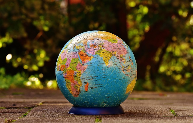 classic globe on stand beside stacked books in a study