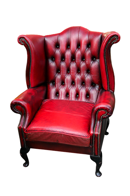 reading chair in leather beside a bookshelf and warm floor lamp in a study